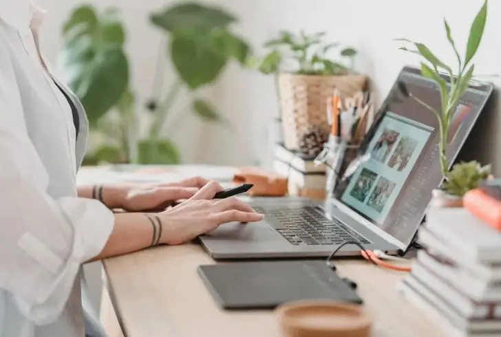 A person working on a laptop from home-Multiple Jobs Trend.